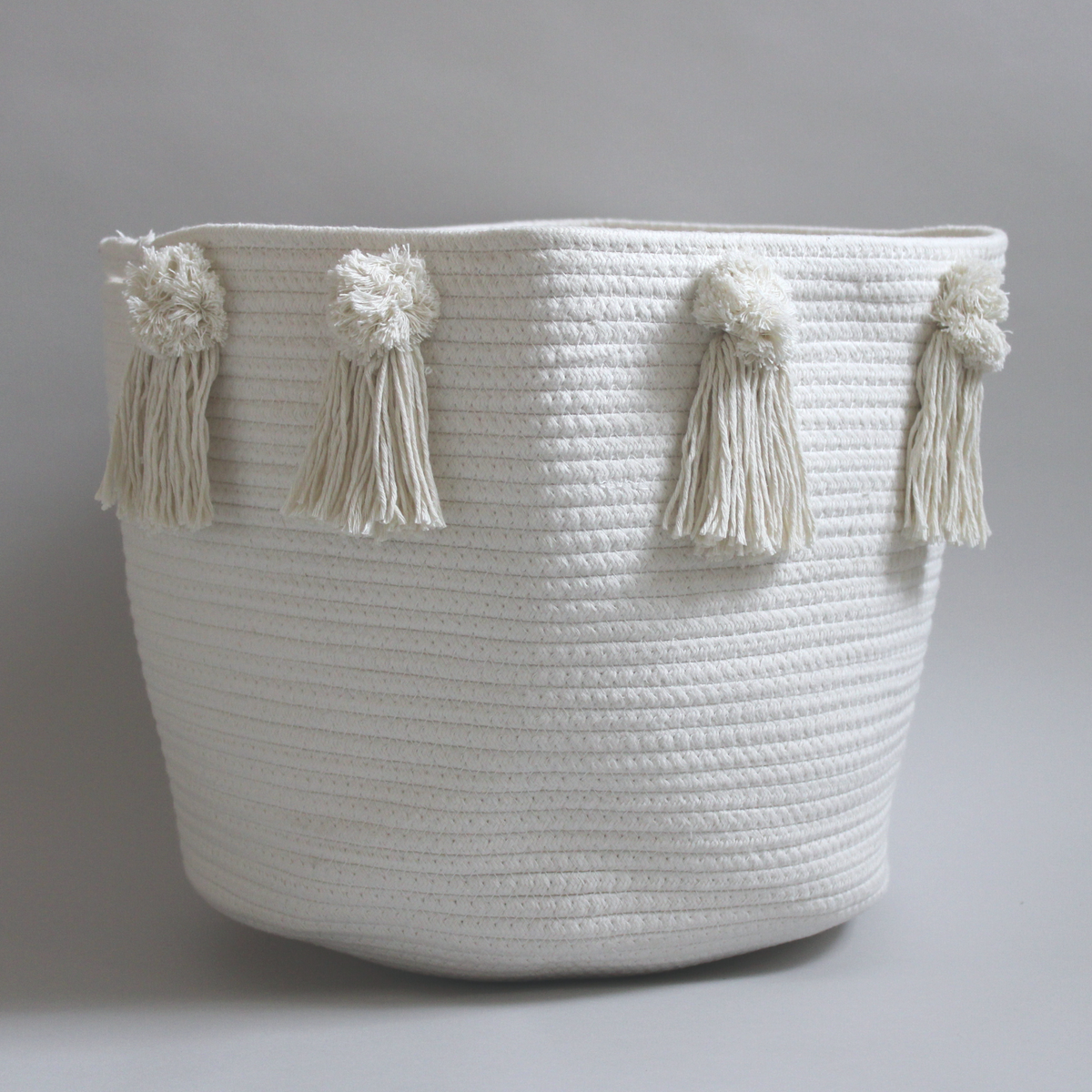Large cotton rope basket with poms and tassels for toy storage