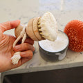 Refillable sisal dish brush and sisal and palm pot scrubber with bamboo handles in a kitchen