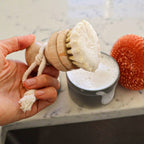 Refillable sisal dish brush and sisal and palm pot scrubber with bamboo handles in a kitchen